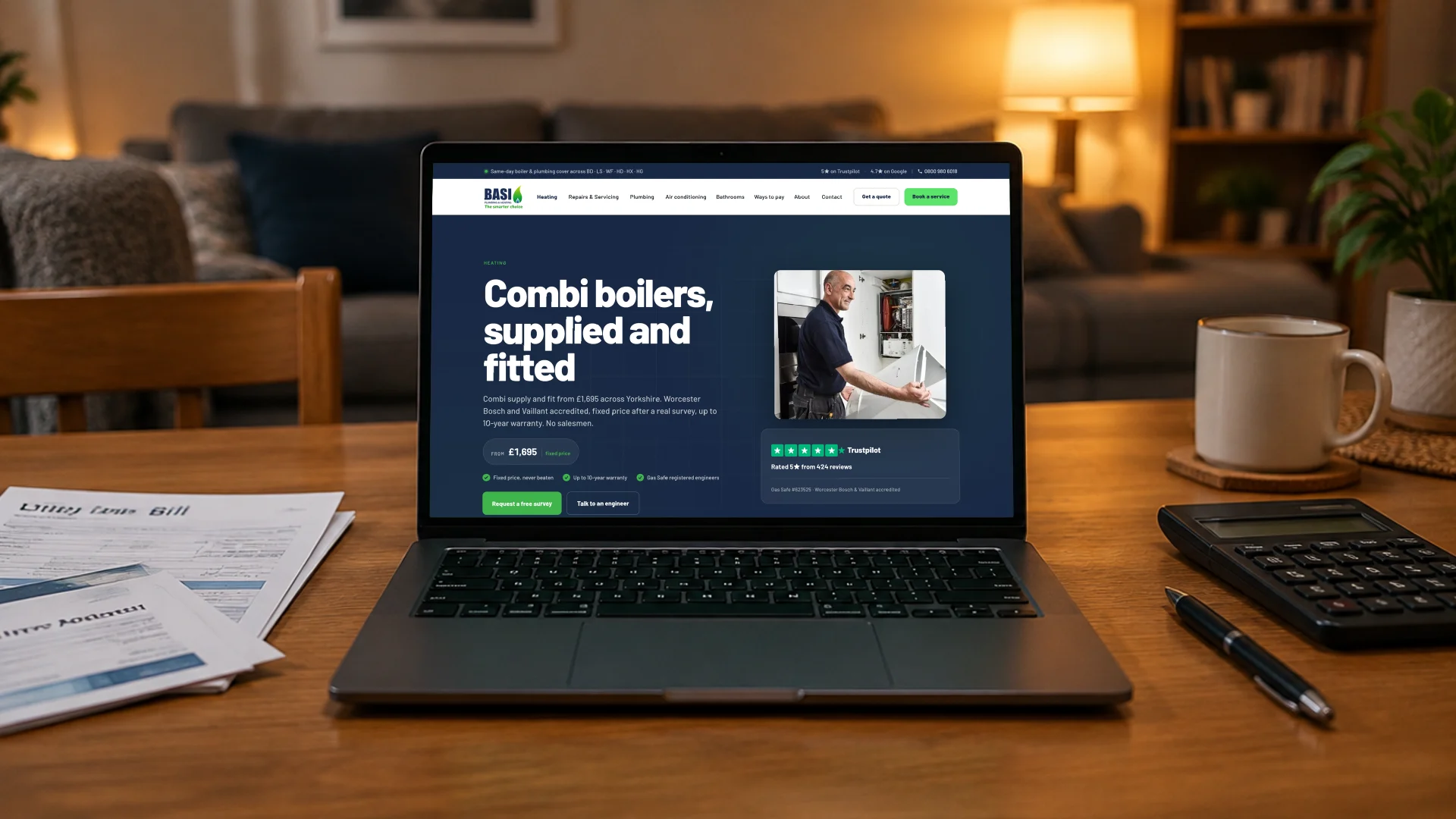 A laptop on a dining table beside household bills and a calculator, showing the BASI Heating combi boilers page with its from-£1,695 fixed price