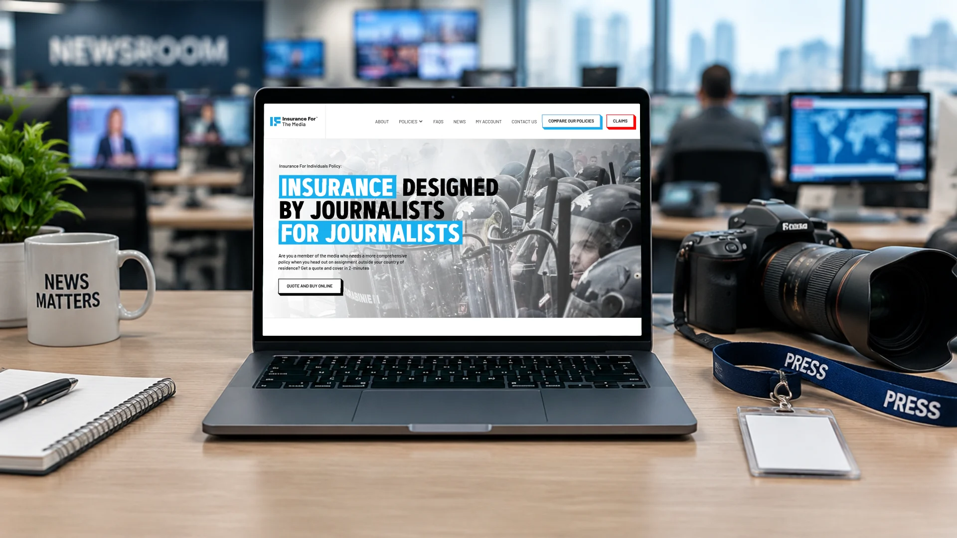 A laptop on a newsroom desk beside a camera and press lanyard, showing the Insurance for the Media page: insurance designed by journalists for journalists