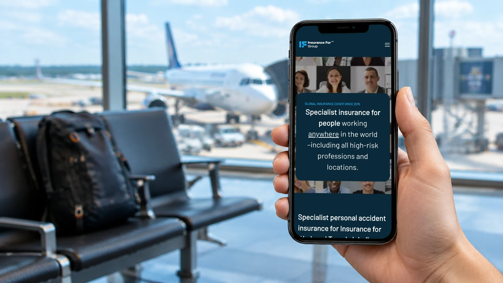A hand holding a phone at an airport departure gate, showing the Insurance For Group site on mobile